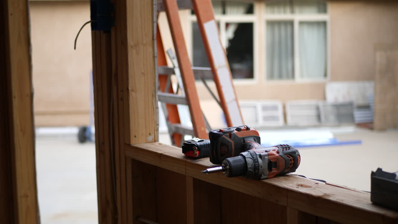 Power tools and drill on the lumber framing of a home construction site