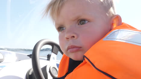 close-up of child driving a boat to play