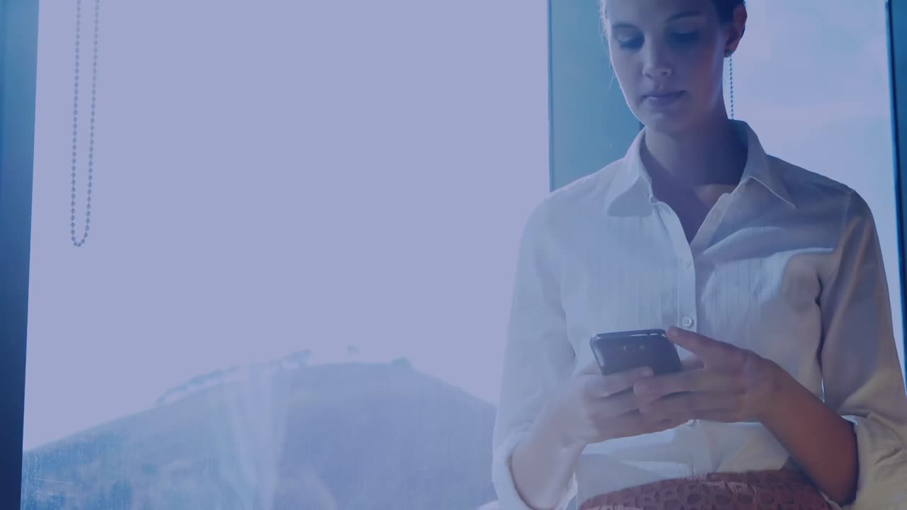 Percentage icons and changing numbers against caucasian businesswoman using smartphone at office