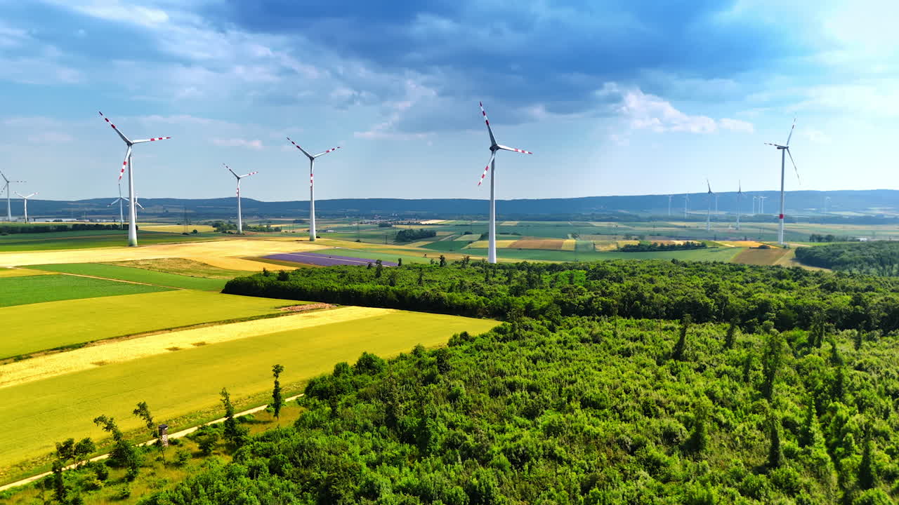 Wind turbines producing clean energy. Wind turbines tower over lush fields, showcasing renewable energy generation amidst a scenic countryside landscape