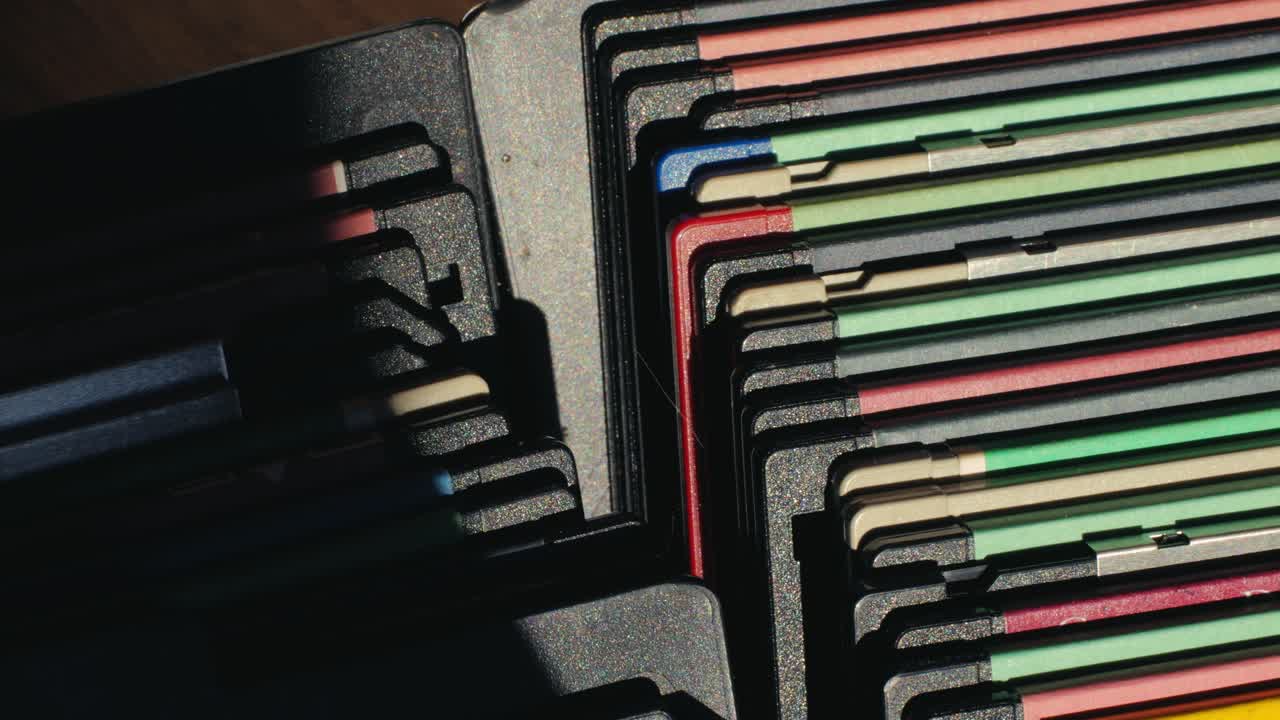 Using diskette for old computer. Music recorder, playing retro computer games. Vintage device for office, obsolete technology. . High quality 4k footage