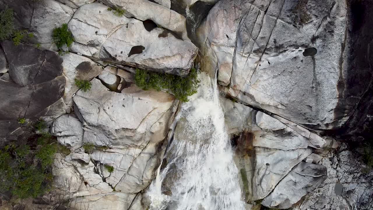 vista aérea de arriba hacia abajo de las cataratas de emerald creek con agua cayendo en cascada por la cara de la roca