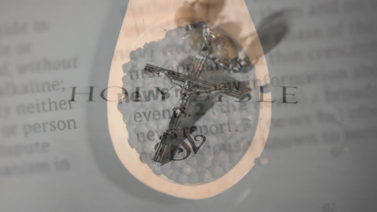 Creating spiritual theme, cross pendant overlaying blurred text