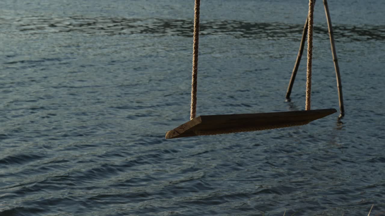 Swing over water on ropes, tranquil moving stream river creek, holiday destination