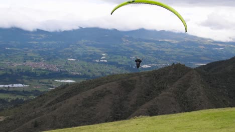 man doing paragliding takeoffs and fly in a beautiful mountain