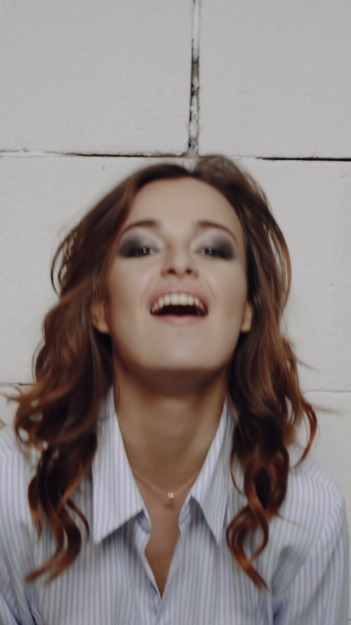 Portrait of a young beautiful brunette with a beautiful make up Vertical video