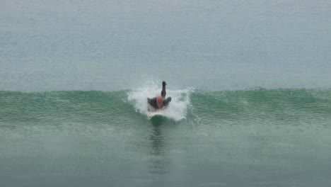 surfer catching and riding a wave