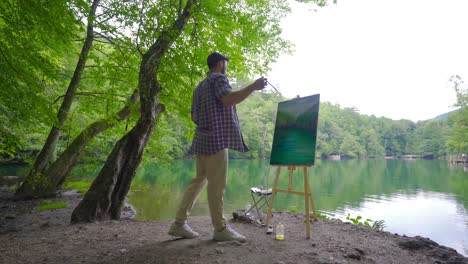 happy painter painting outdoors.