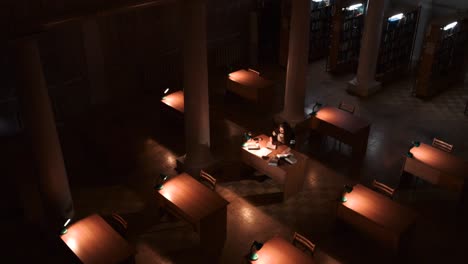 student studying in a dark library