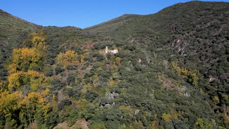 aerial view of abandoned church ruins in a mountain forest