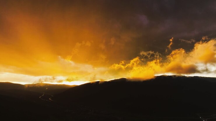 dynamic shifting sunset and fast-moving atmospheric clouds over a town in Colorado vibrant sunset hyper lapse AERIAL STATIC