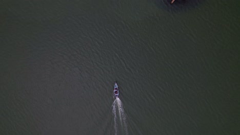 Drone-shot-of-moving-fishing-boat-from-above