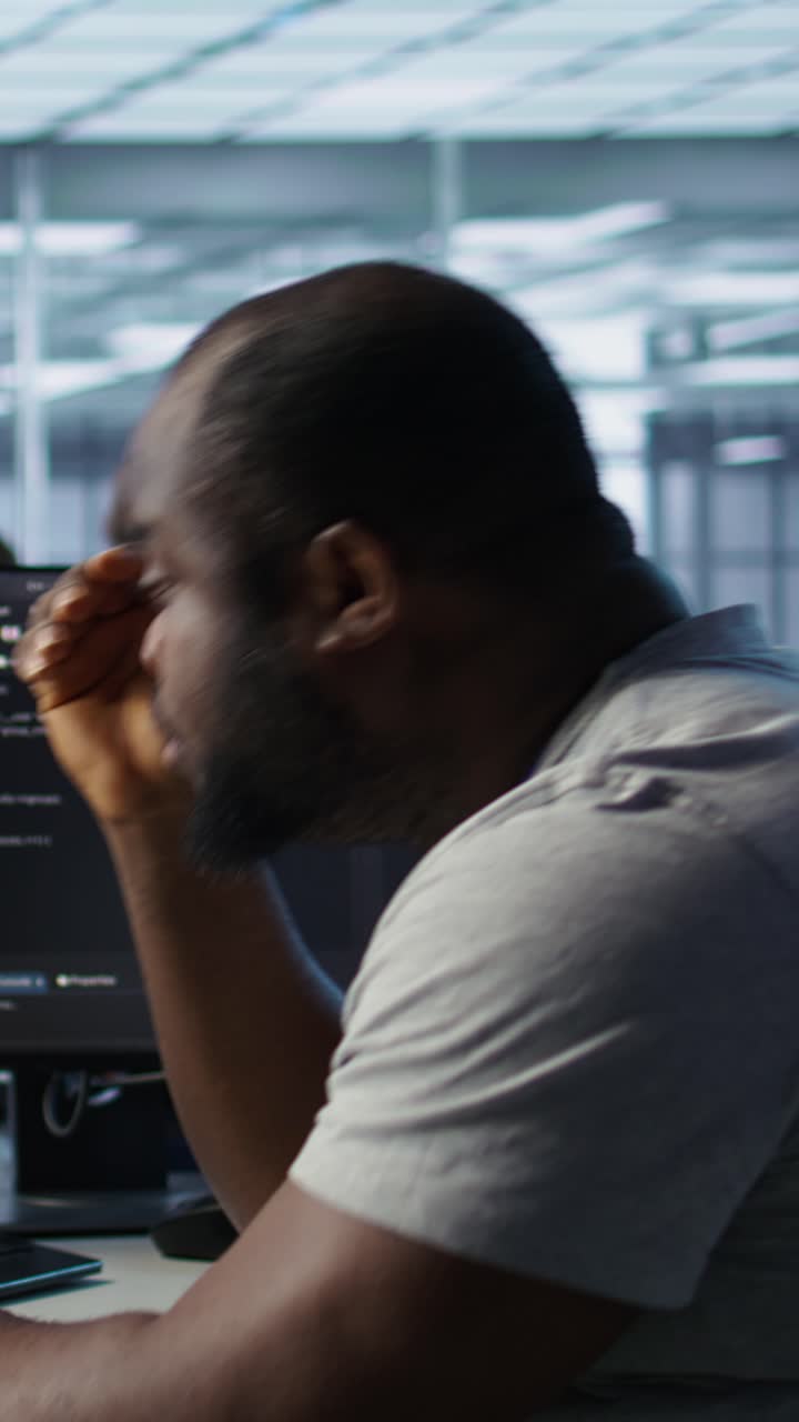 Tired African American Programmer Working on Code in Modern Office