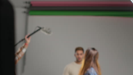 female film director and assistant watching actors shooting movie or video in studio on monitor 4