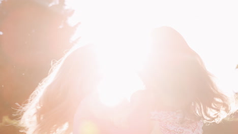 Mother-Playing-In-Garden-At-Home-With-Daughter