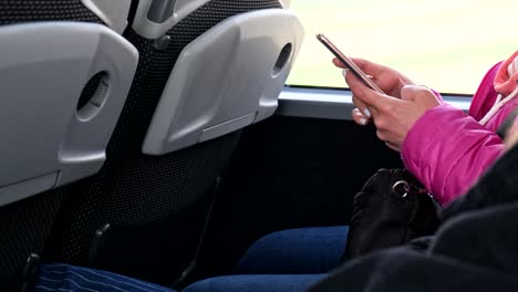 woman surfing internet on the phone coach bus travel