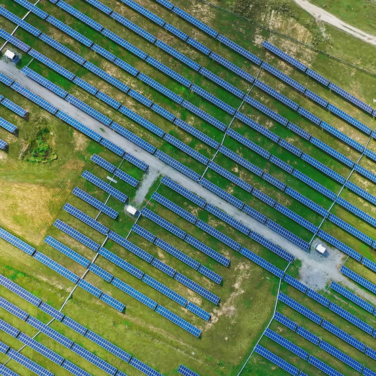 Solar energy panels on the field. Top aerial view on the solar power farm. Renewable green alternative energy concept. Motion camera around.