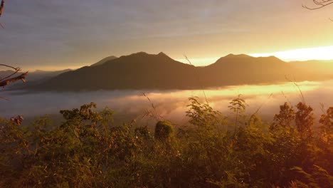 panoramic view of mountain range with sea of clouds in foreground during a beautiful sunset in thailand