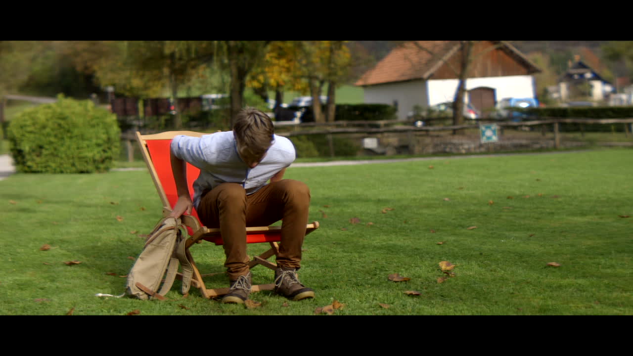 Teenager relaxing in a folding chair outdoors
