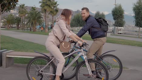 couple cycling in a park