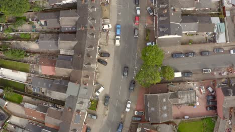 drone shot car driving down housing estate street