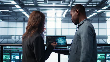 software developers in data center using laptop, employing ai machine learning
