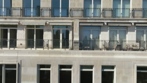 drone shot rising in front of the facade of a luxury condo in sunny manhattan, ny