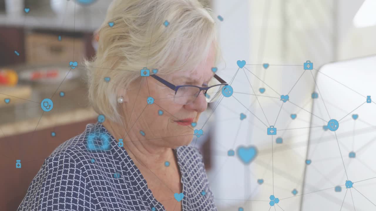 Senior woman analyzing data on monitor while computer showing drifting icons and adjusting glasses