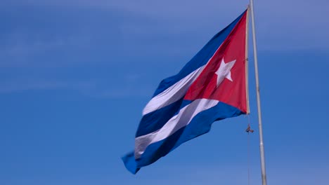 the flag of cuba flies in the sky