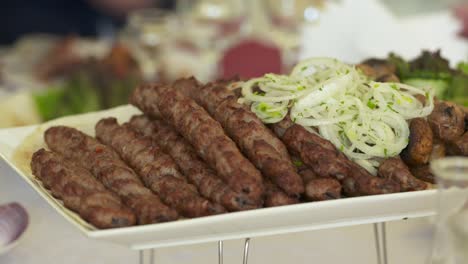 mesa de cena servida con kebabs lula y verduras frescas