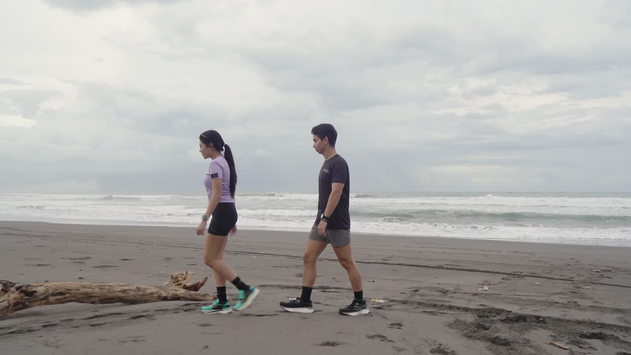 Couple enjoying a walk on the beach