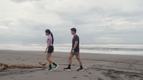 couple enjoying a walk on the beach