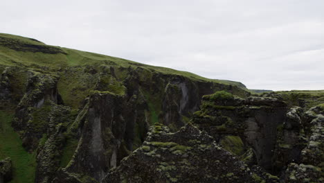 Medium-shot-with-a-left-to-right-pan-over-the-top-of-the-canyon-cliffs-in-Fjadrargliufur