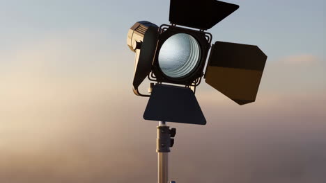 professional studio light against a sunset sky