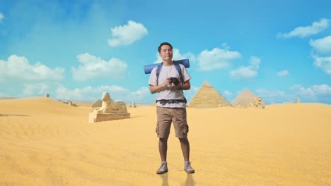 man with camera in front of egyptian pyramids