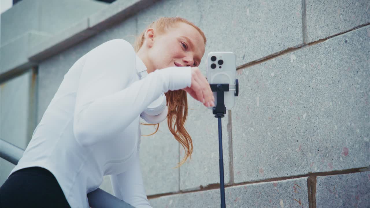 Woman with phone and headphones