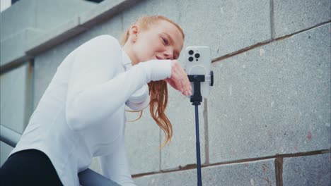 woman with phone and headphones