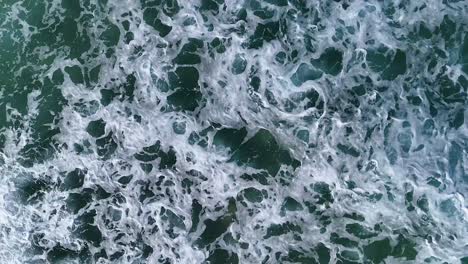 aerial view of ocean waves and foam