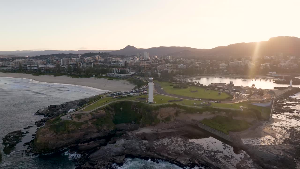 Aerial drone view of Wollongong, showcasing its scenic coastal cityscape and iconic lighthouse during a bright sunny day