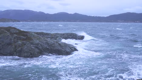 norway atlantic ocean, waves crashing upon rocks, camera zooming in