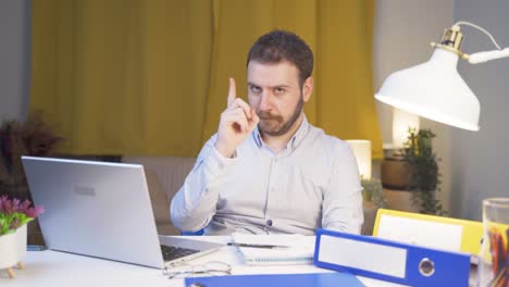 home office worker man looking at camera with a stern angry warning.