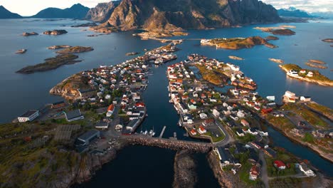 Henningsvaer village on islands, seaside homes, and the iconic football pitch near mountains. Lofoten, Norway.