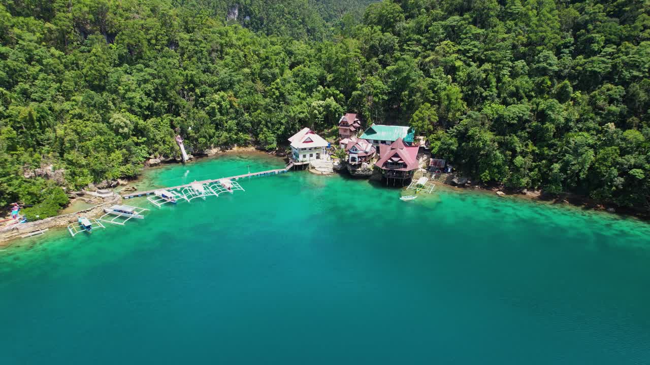 4K drone video flying back from Tiktikan Lagoon Cottages in Sohoton Cove near Siargao Island in The Philippines