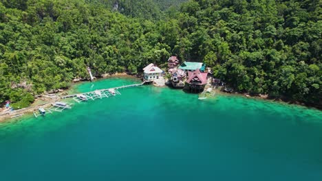 4k drone video flying back from tiktikan lagoon cottages in sohoton cove near siargao island in the philippines