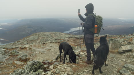 person is taking picture of landscape with two dogs in slow motion