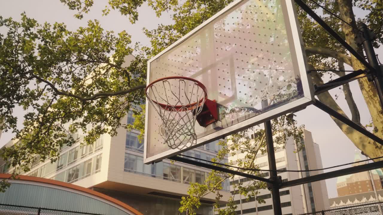 Empty outdoor basketball hoop, rim and net with apartment building in background, New York, USA