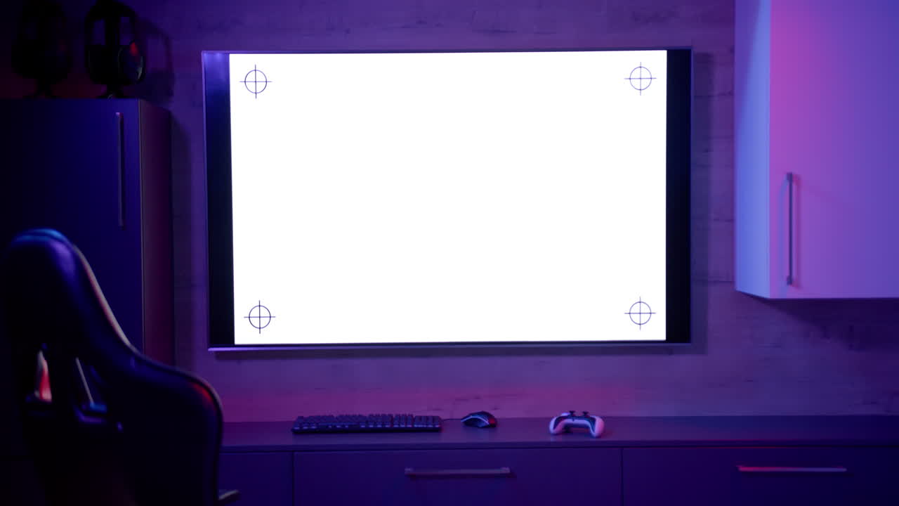 Gaming setup with large screen, keyboard, mouse, and controller in modern home, copy space