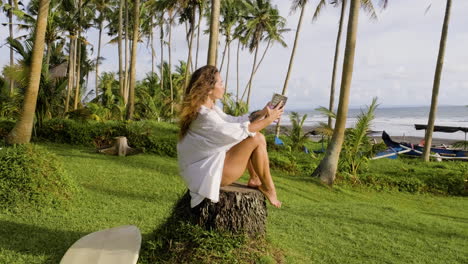 mujer sentada al lado de la tabla de surf