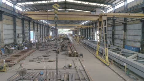 gantry cranes and steel materials and structures in a fabrication plant. drone
