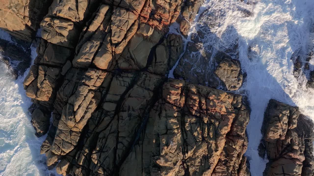 Sea Waves Hit Granite Rocks At Parque de Punta Herminia In A Coruña, Spain. Aerial Topdown Shot